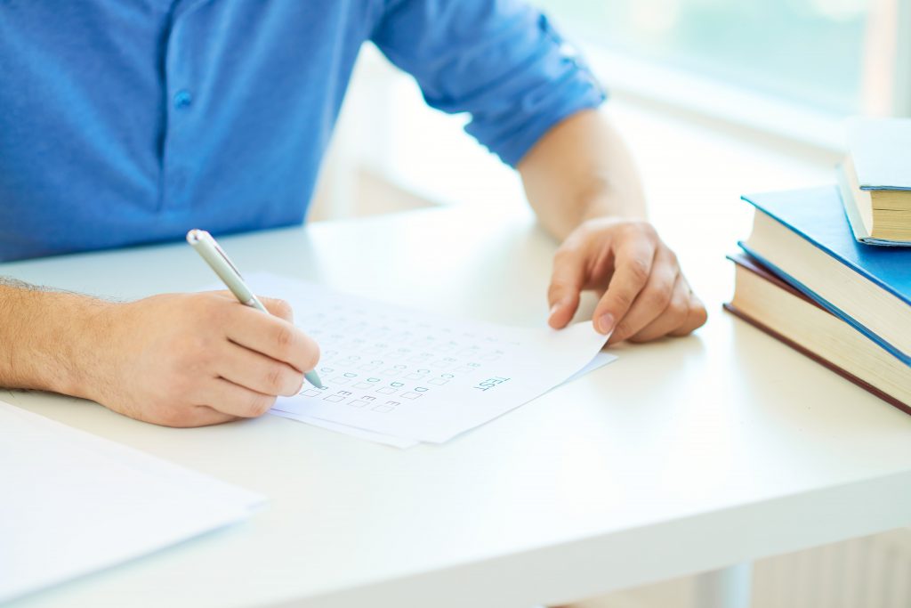 guy writing on a paper