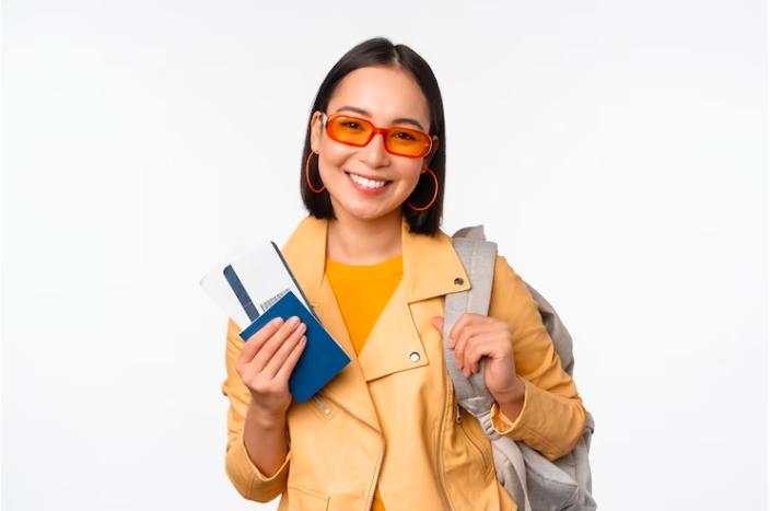 Woman in a yellow suit holding a passport and ESTA