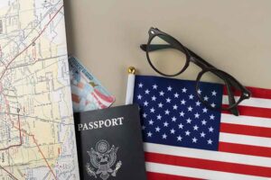 assorted image of map green card and passport and eyeglasses
